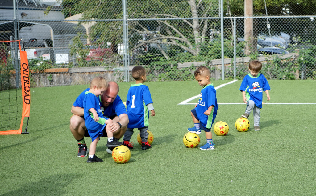 Coach helps a child learn a new skill
